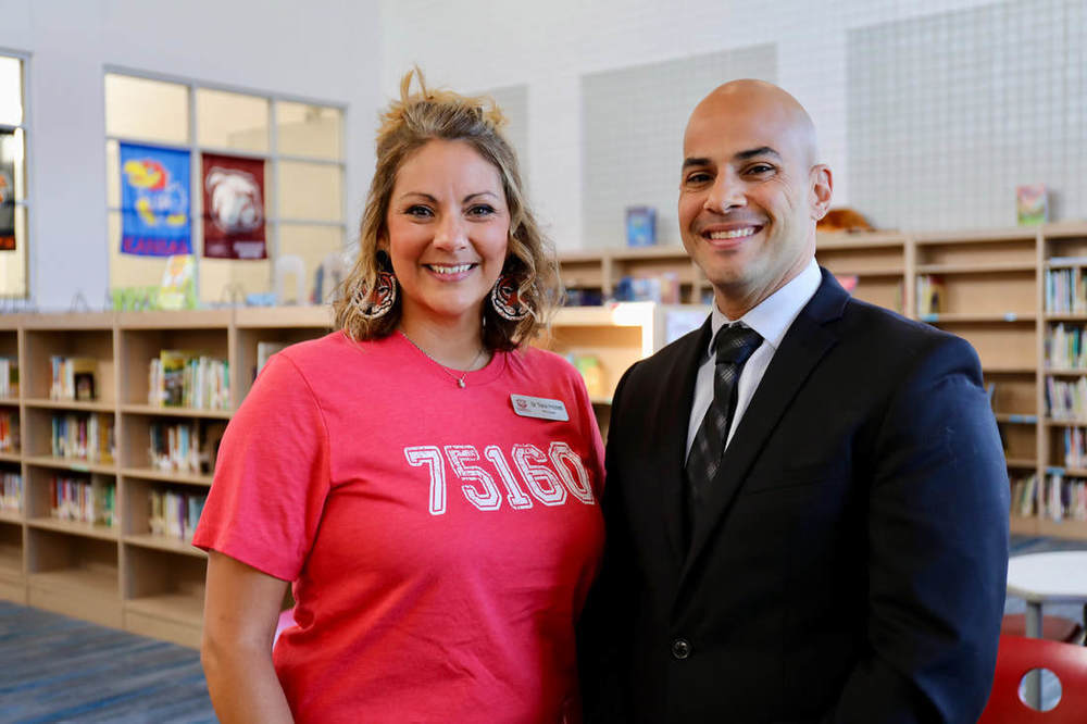 Dr. Tracie Pritchett standing with Aleix Santiago in library